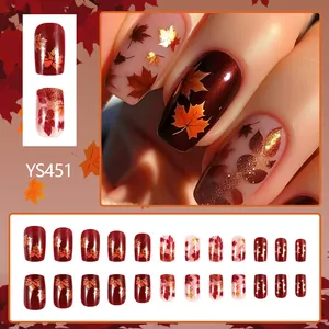 Short vintage dark glitter press-on nails with autumn maple leaf designs and gold accents