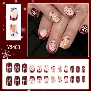 Short Christmas press-on nails with gingerbread man and red glitter snowflakes