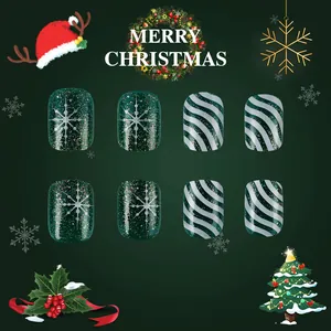 Close-up of Christmas short nails with green glitter, silver snowflakes, and stripes