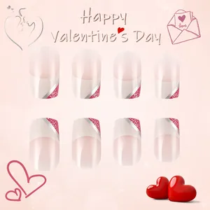 Detail of short square French nails with red glitter accents for Valentine's Day