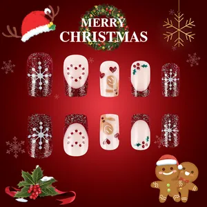 Close-up of Christmas press-on nails with gingerbread man and snowflake art designs
