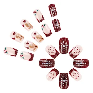 Short square Christmas press-on nails featuring gingerbread man and snowflake patterns