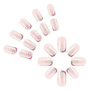 Short square press-on nails with pink base, white French tips and red heart glitter designs