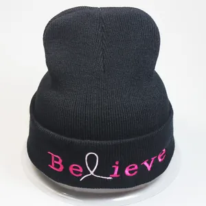 Black knit beanie featuring pink Believe embroidery with a symbolic ribbon graphic