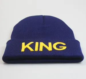 Detail der gelben KING Bestickung auf dunkelblauer Strickmütze mit Rippstruktur