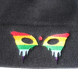 Black knit beanie featuring a colorful rainbow butterfly embroidery with a dripping effect