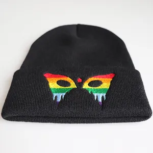 Black knit beanie with vibrant rainbow embroidered mask pattern for winter warmth