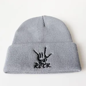 Gray knit beanie with black Rock embroidery and hand gesture on a white background