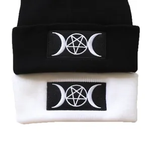 Goth beanie with mystic pentagram embroidery shown in black and white knit colors