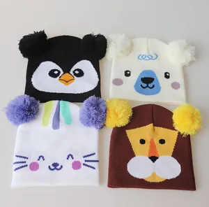 Detail of four colorful animal-themed knit beanies for kids with double pom-poms