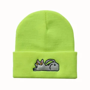 Detailansicht der grauen Katzenstickerei auf einer neongrünen Rippstrickmütze für Winter