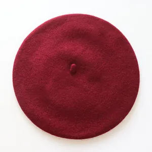 Vue de dessus détaillée d'un béret en laine rouge foncé montrant sa texture en feutre épais