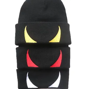 Three black knit beanies featuring yellow, red, and white devil horn embroidery