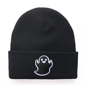 Black knitted ghost beanie with white embroidery and wide cuff for winter warmth