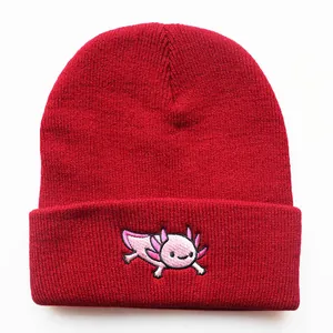 Detailed close-up of pink axolotl embroidery on a dark red ribbed knit beanie hat