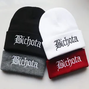 Detail of Bichota gothic embroidery on colorful ribbed knit beanies for winter
