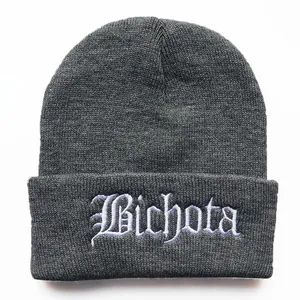 Dark grey knit beanie with white Bichota embroidery and classic wide folded cuff design