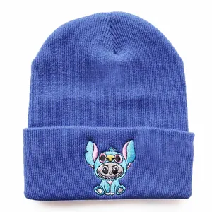 Close-up of the knitted texture and detailed blue cartoon character embroidery on the beanie