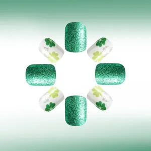 Close-up of Saint Patrick's Day green glitter and shamrock pattern press-on nails
