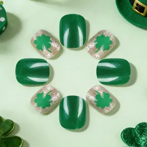 Macro shot of St. Patrick's Day short square nails with shamrock design and green cat eye finish