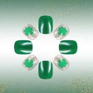 Macro detail of St. Patrick's Day green and silver glitter press-on nails with shamrocks