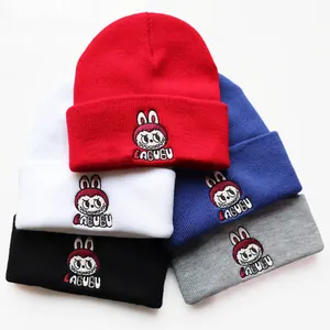 Stack of colorful knitted beanies with embroidered Labubu characters in five distinct colors