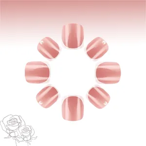 Close-up of pink glossy press-on nails with 3D pearl accents and French style tips