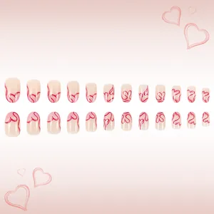 Detail of 24 short almond press-on nails with pink gradient and red heart line patterns