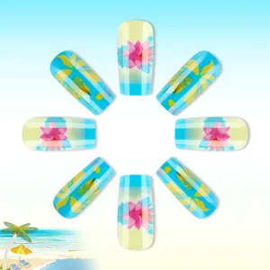 Detail of tropical press-on nails featuring pink flowers and yellow palm leaf patterns