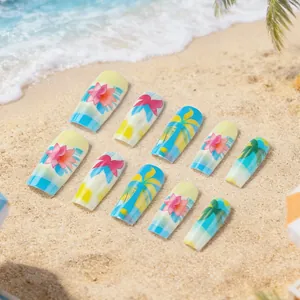 Colorful tropical press-on nails featuring palm trees and floral designs on sandy beach