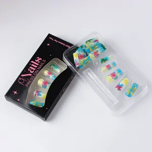 Detail of press on nails with tropical floral palm patterns and branded black packaging
