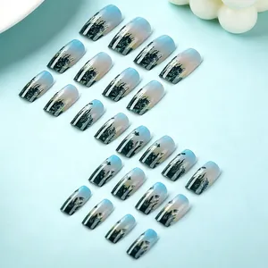 Detail of 24pcs blue gradient press-on nails with black tropical leaf silhouette prints