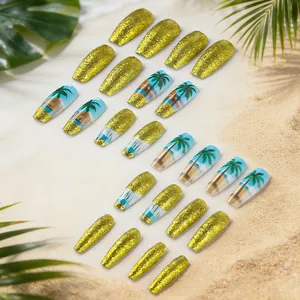 Detail of long coffin press-on nails with tropical palm tree art and gold glitter finish