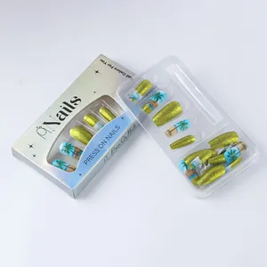 Detailed set of tropical palm tree press-on nails with gold glitter in retail packaging