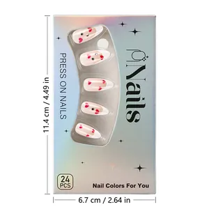 Close-up of heart pattern French press-on nails in iridescent packaging box