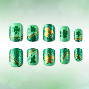 Short square St. Patrick's Day press-on nails with green shamrocks and gold glitter patterns