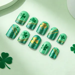Short square St. Patrick's Day press-on nails with green clover and gold glitter designs