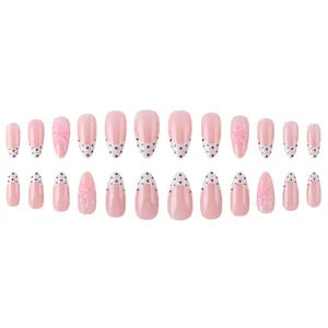 Unghie finte a mandorla french con fiori 3D rosa e pois neri su base color carne nude