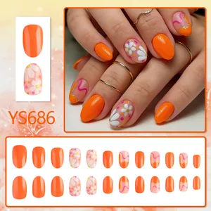 Short oval orange press-on nails with daisy flower patterns and glitter glossy finish