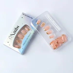 Detail of pink press-on nails with golden French tips and 3D bow on white background