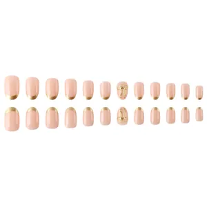 French style nude pink press-on nails with gold tips and 3D bow accents, 24-piece set