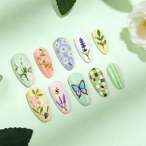 Green almond press-on nails with floral daisy, butterfly and checkerboard designs