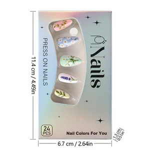 Detail of green almond press-on nails with floral designs in laser holographic packaging