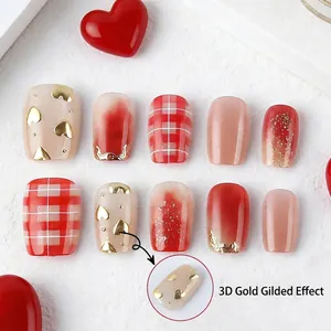 Short square press-on nails with red heart patterns and 3D gilded effect for women