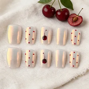 Short cream pearlescent press-on nails with 3D embossed cherry patterns and red polka dots