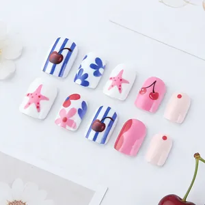 Short square press-on nails with pink flowers, cherries, and blue stripes pattern