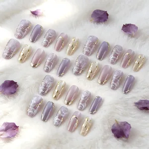Elegant almond shaped purple press-on nails with gold foil and hand-painted floral design
