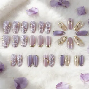 Purple press-on nails with gold foil accents and floral art in short almond shape