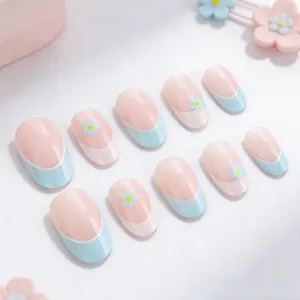 Blue French almond press-on nails with white floral patterns on translucent base