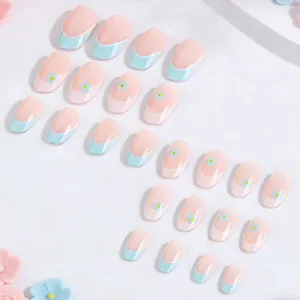 Detailed close-up of 24pcs French almond press-on nails with blue and white floral designs